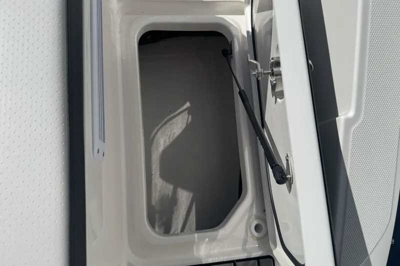 Slide: The Image of Open storage compartment on a 2026 Sea Ray SPX 210 boat. - 28