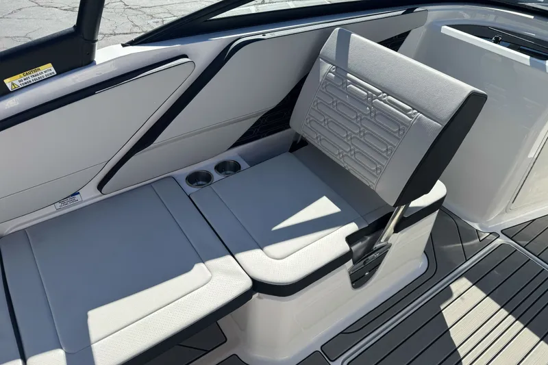 Slide: The Image of 2026 Sea Ray SPX 210 boat interior with cushioned seating and cup holders. - 21