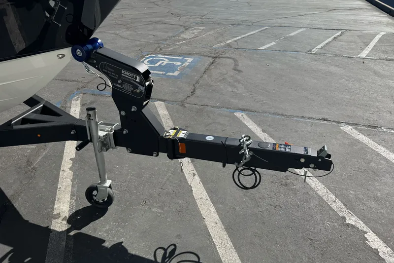 Slide: The Image of Trailer hitch of a 2026 Sea Ray SPX 210 boat in a parking lot. - 2