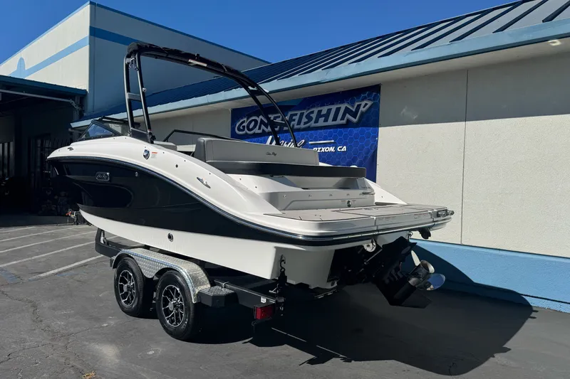 Slide: The Image of 2026 Sea Ray SPX 210 boat on trailer, parked outside a building. - 5