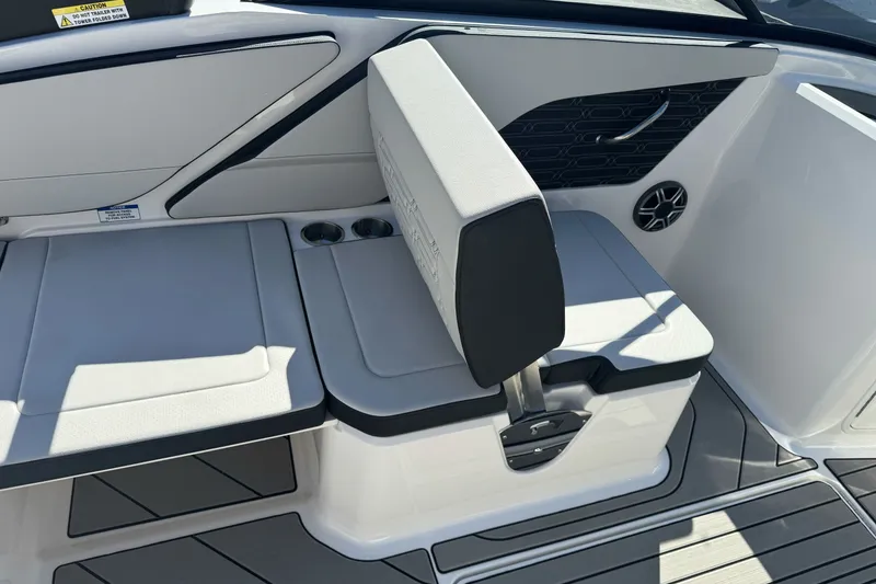 Slide: The Image of 2026 Sea Ray SPX 210 boat interior with cushioned seating and cup holders. - 10