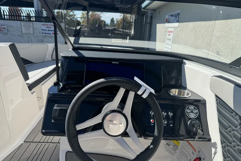Slide: The Image of 2026 Sea Ray SPX 210 boat dashboard with steering wheel and control panel. - 11