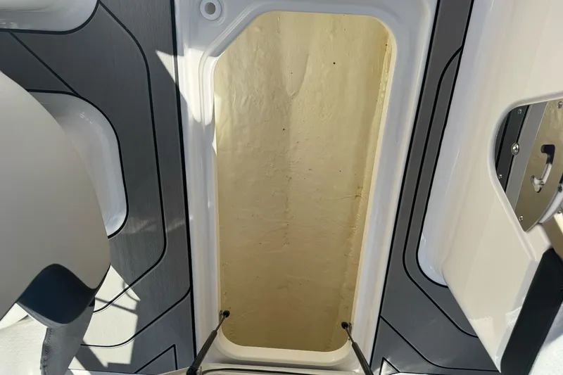 Slide: The Image of Storage compartment on a 2026 Sea Ray SPX 210 boat, featuring sleek interior design. - 22