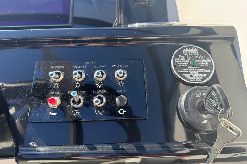 Slide: The Image of Control panel of a 2026 Sea Ray SPX 210 boat with ignition and switches. - 12