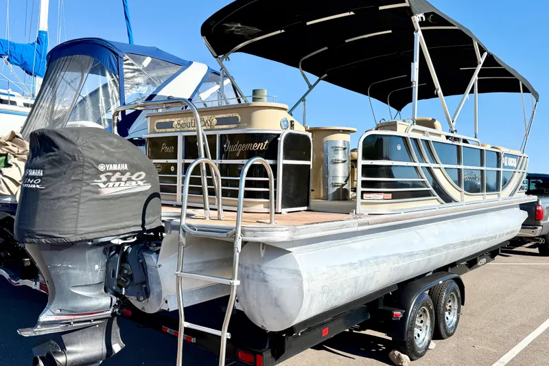 Slide: The Image of 2014 South Bay 724 E DLX TT pontoon boat with Yamaha engine on trailer. - 1