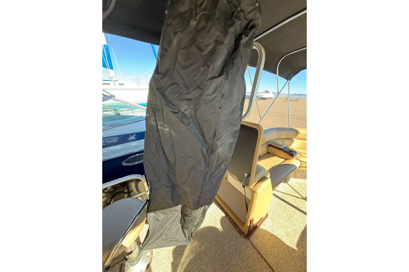 Slide: The Image of 2014 South Bay 724 E DLX TT boat interior with seating and protective cover. - 18