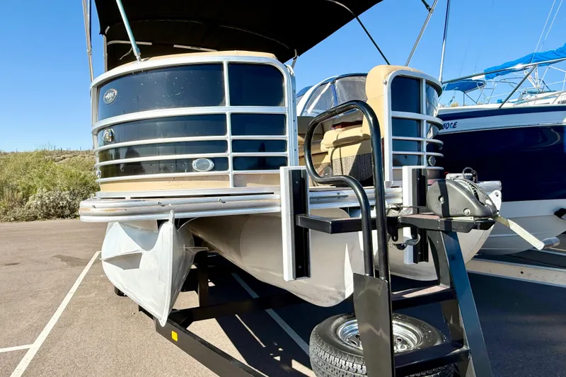 Slide: The Image of 2014 South Bay 724 E DLX TT pontoon boat on trailer, parked outdoors. - 3