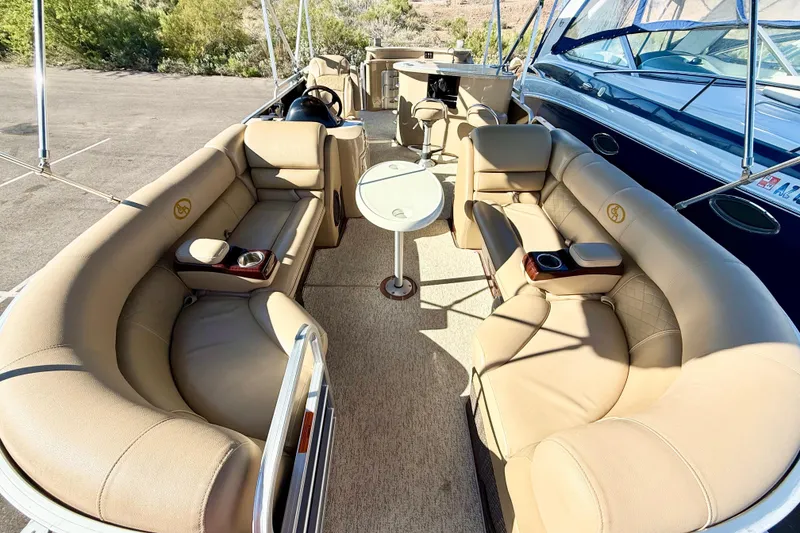 Slide: The Image of 2014 South Bay 724 E DLX TT pontoon boat with beige seating and table. - 4