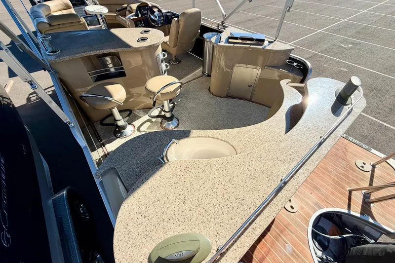 Slide: The Image of Luxurious 2014 South Bay 724 E DLX TT pontoon boat interior with bar and seating area. - 5