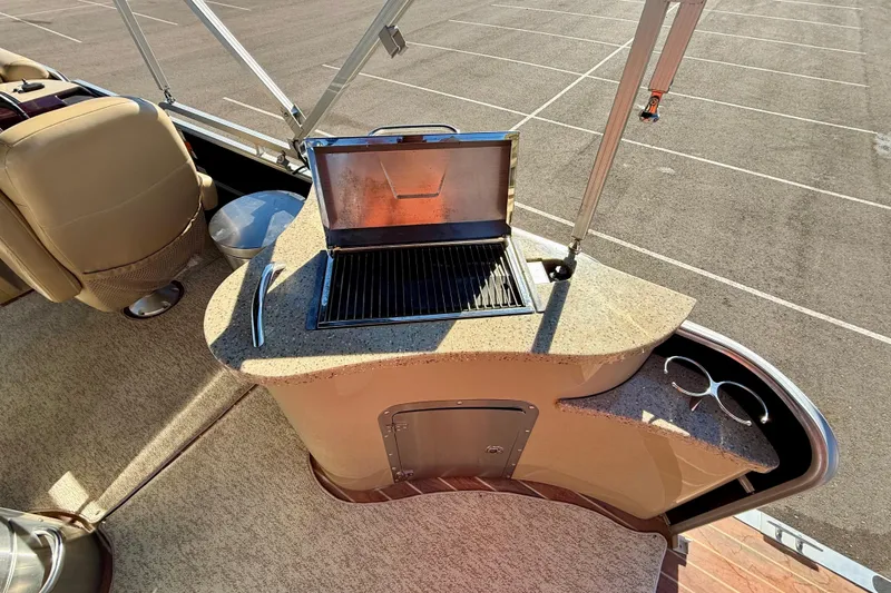 Slide: The Image of 2014 South Bay 724 E DLX TT boat with built-in grill and seating area. - 7