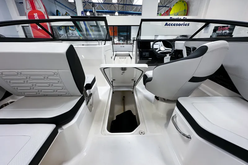 Slide: The Image of 2026 Sea Ray SPX 210 Outboard boat interior with sleek seating and modern dashboard. - 14
