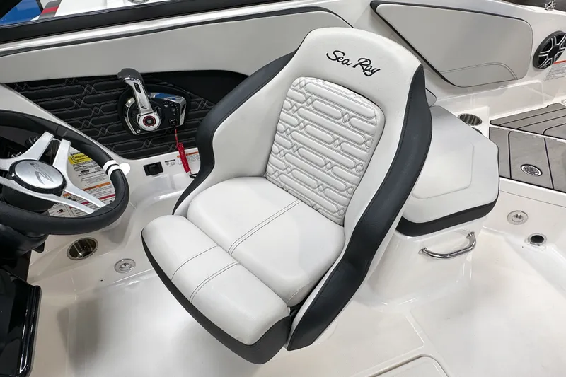 Slide: The Image of Captain's seat of 2026 Sea Ray SPX 210 Outboard boat, featuring sleek design and controls. - 6