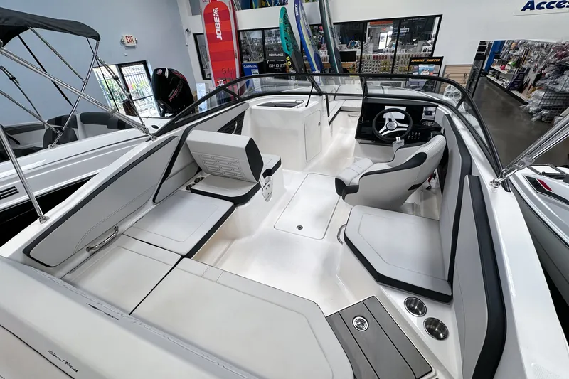 Slide: The Image of 2026 Sea Ray SPX 210 Outboard boat interior with sleek seating and modern dashboard. - 5