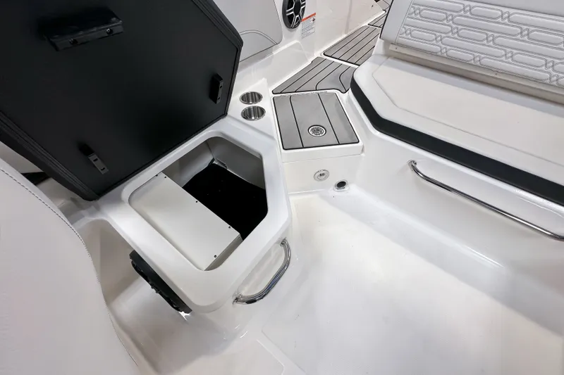 Slide: The Image of 2026 Sea Ray SPX 210 Outboard boat interior with open storage compartment and seating area. - 15