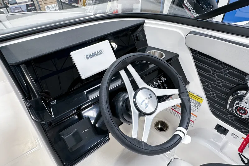 Slide: The Image of 2026 Sea Ray SPX 210 Outboard dashboard with Simrad display and steering wheel. - 7