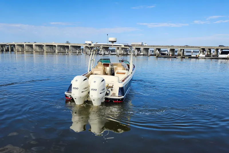 Slide: The Image of 2016 Chris-Craft Calypso 26 boat with twin Yamaha engines on calm water. - 10