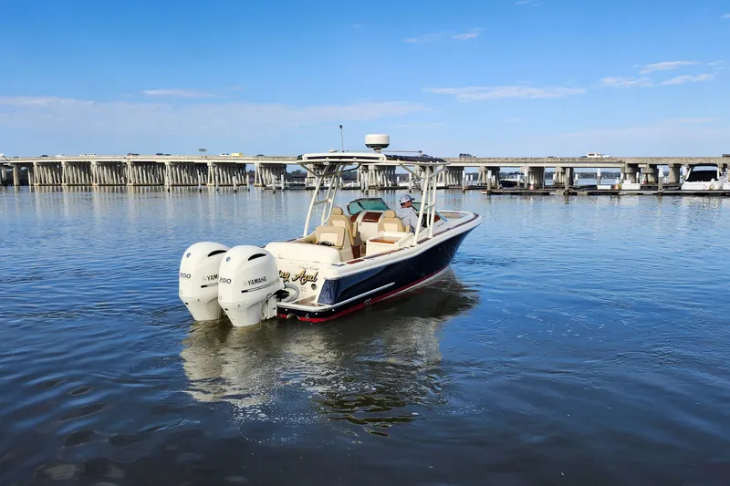Slide: The Image of 2016 Chris-Craft Calypso 26 boat with twin Yamaha engines on calm water. - 11