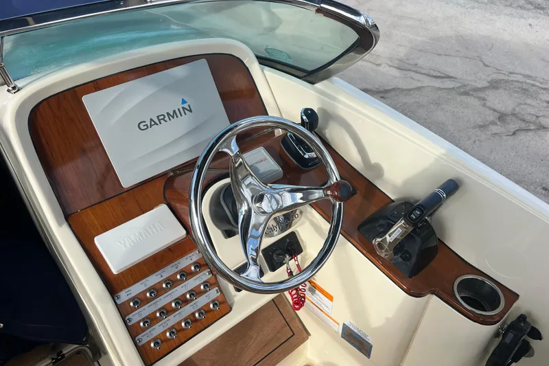 Slide: The Image of 2016 Chris-Craft Calypso 26 helm with Garmin navigation and Yamaha controls. - 23