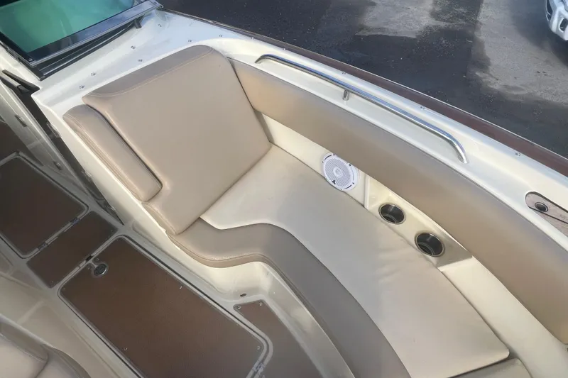 Slide: The Image of 2016 Chris-Craft Calypso 26 boat interior with beige seating and cup holders. - 33