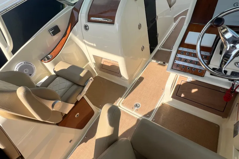 Slide: The Image of Interior of 2016 Chris-Craft Calypso 26 boat, featuring luxurious seating and polished controls. - 40
