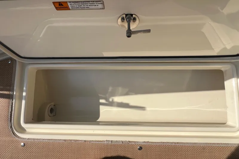 Slide: The Image of Storage compartment on a 2016 Chris-Craft Calypso 26 boat, open and empty. - 43