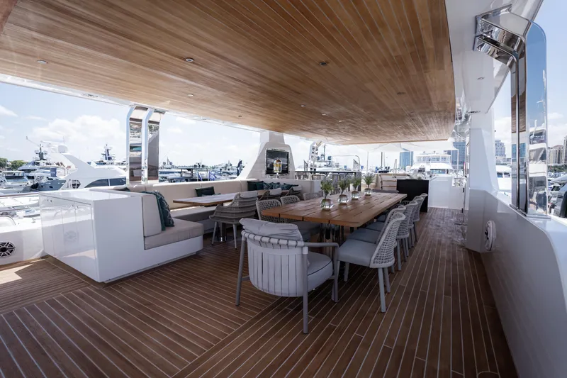Slide: The Image of Luxurious 2020 Alpha Alfresco 125 yacht deck with elegant dining area and marina view. - 15