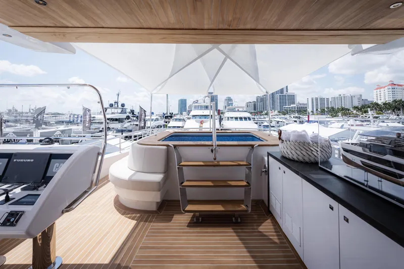Slide: The Image of Luxurious 2020 Alpha Alfresco 125 yacht deck with seating, pool, and marina view. - 16