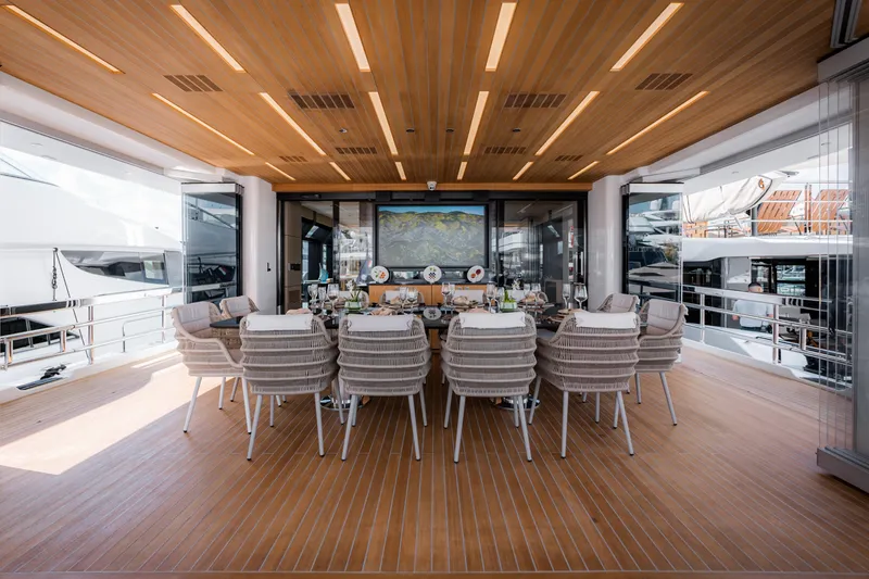Slide: The Image of Luxurious dining area on 2020 Alpha Alfresco 125 yacht, featuring elegant seating and modern decor. - 17