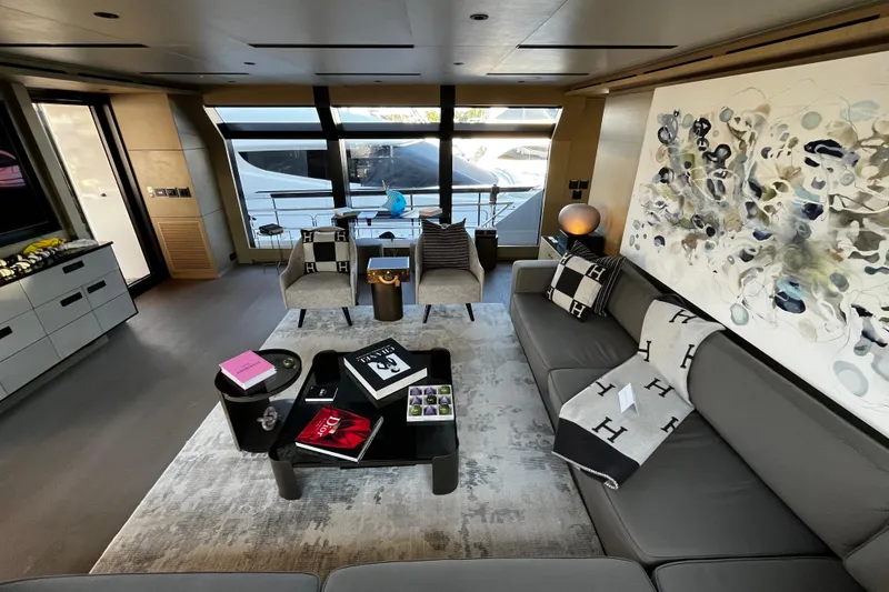 Slide: The Image of Luxurious yacht interior with modern decor, featuring a stylish seating area and abstract wall art. - 22