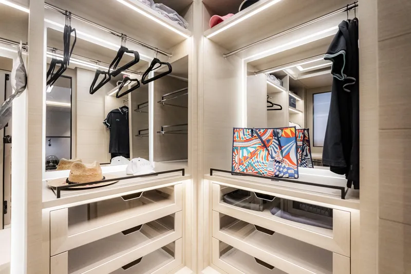 Slide: The Image of Luxurious walk-in closet with modern lighting, stylish storage, and colorful bag on display. - 30