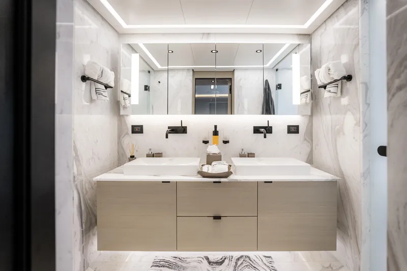 Slide: The Image of Luxurious modern bathroom with dual sinks, marble walls, and elegant lighting in Alpha Alfresco 125 yacht. - 31