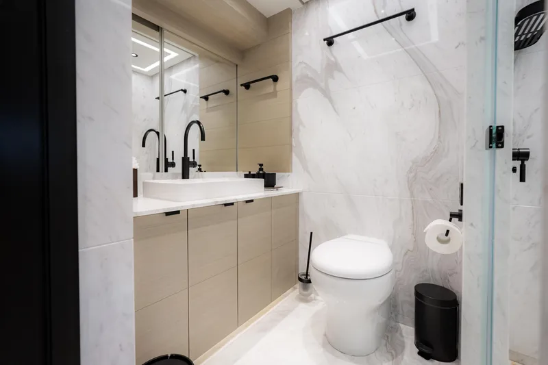 Slide: The Image of Modern bathroom with marble walls, sleek fixtures, and a minimalist design. - 33