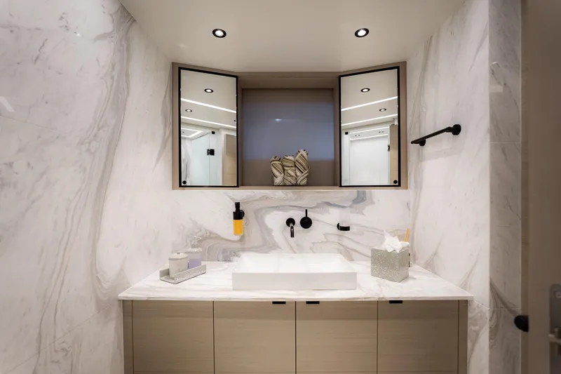 Slide: The Image of Modern bathroom with marble walls, dual mirrors, and sleek fixtures in an Alpha Alfresco 125, 2020. - 38