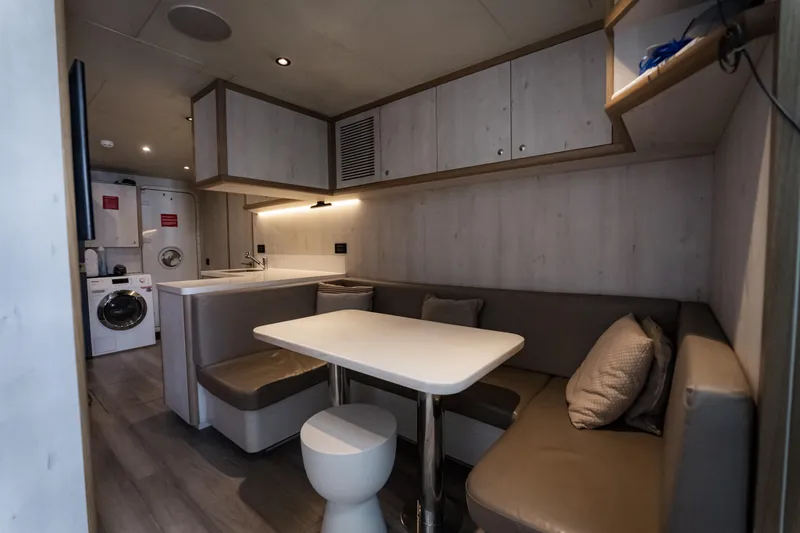 Slide: The Image of Modern interior of 2020 Alpha Alfresco 125 with cozy seating and compact kitchen. - 39