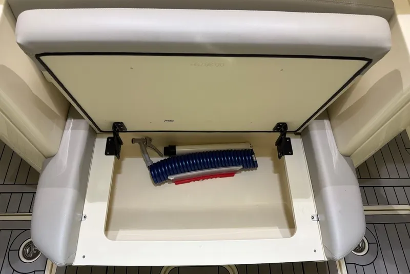 Slide: The Image of Storage compartment in 2023 Scout 330 LXF boat with hose. - 16