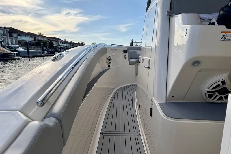 Slide: The Image of Scout 330 LXF 2023 yacht deck with sleek features by the water. - 20