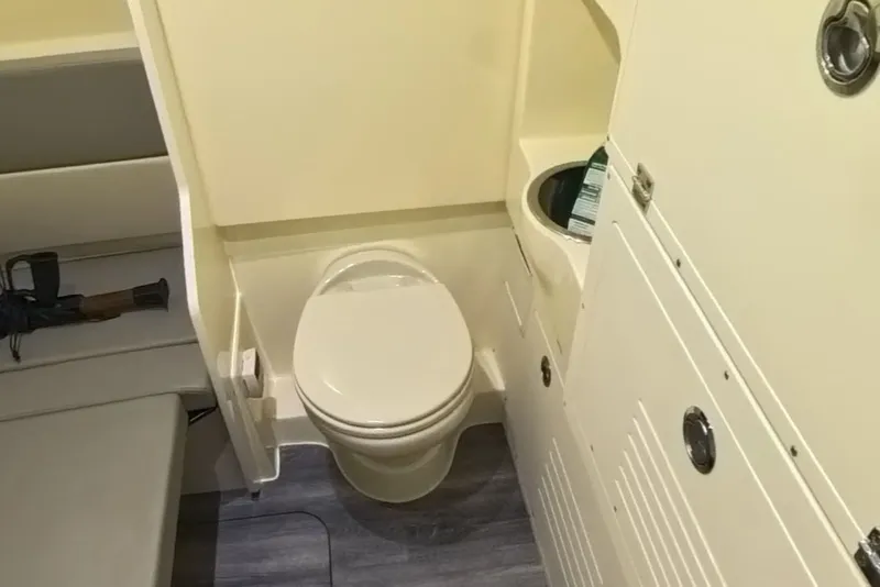 Slide: The Image of Interior of 2023 Scout 330 LXF featuring toilet and seating area. - 48