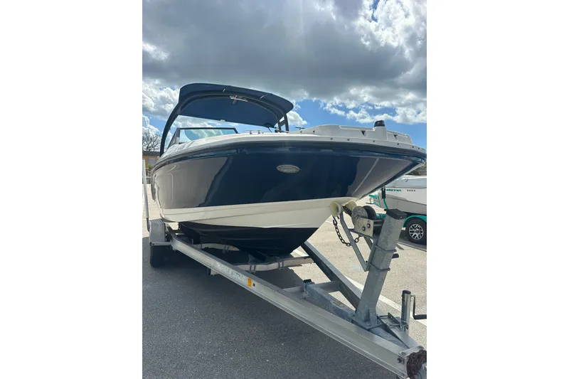 The Image of 2022 Sea Ray SPX 210 Outboard boat on trailer, parked in sunny lot. - 0