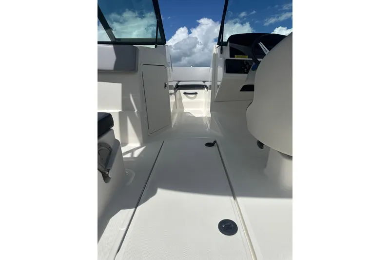Slide: The Image of 2022 Sea Ray SPX 210 Outboard boat interior with gray seating and helm. - 10