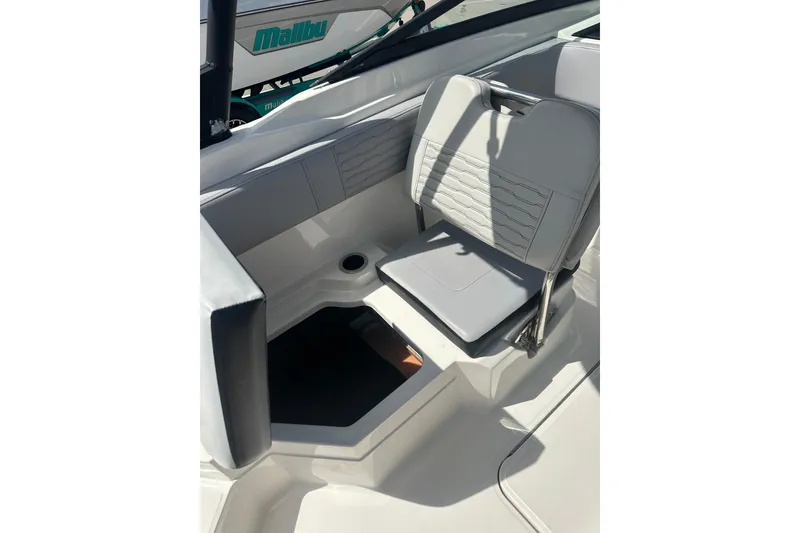 Slide: The Image of 2022 Sea Ray SPX 210 Outboard boat interior with seating and steering wheel under blue sky. - 11
