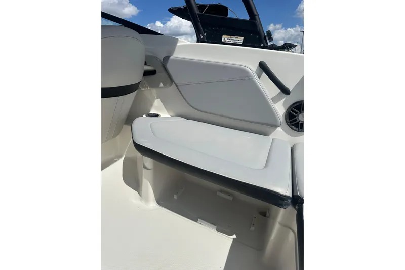 Slide: The Image of 2022 Sea Ray SPX 210 Outboard boat interior with gray seating and storage compartment. - 13