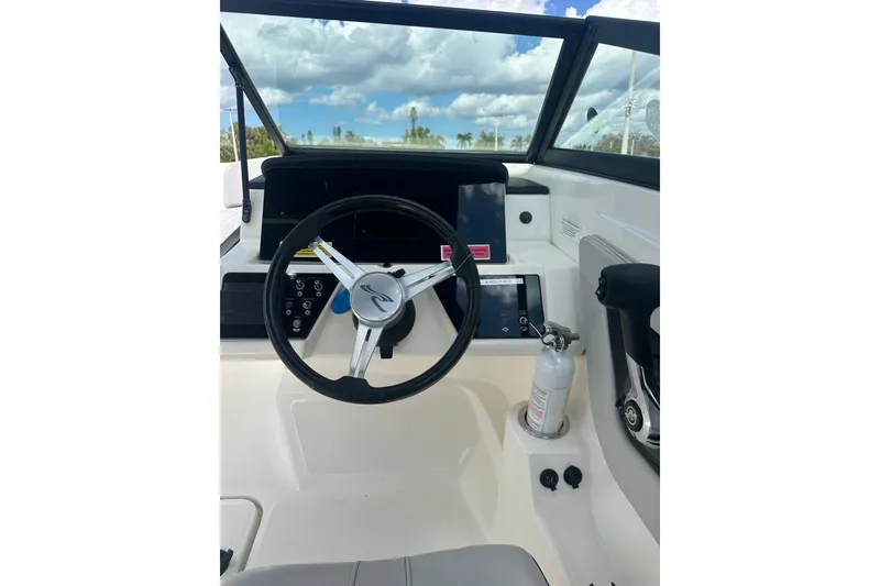 Slide: The Image of 2022 Sea Ray SPX 210 Outboard interior with seating and console details. - 14