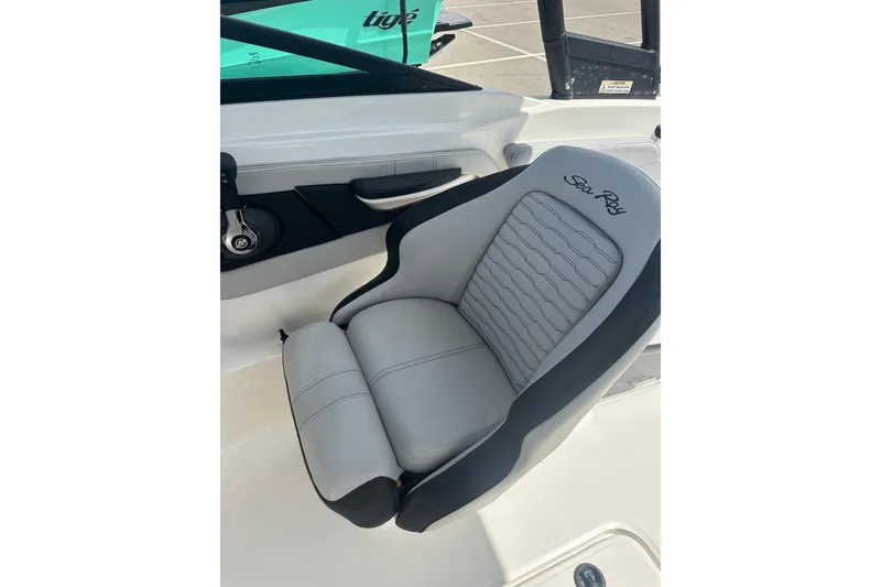 Slide: The Image of 2022 Sea Ray SPX 210 Outboard boat cockpit with steering wheel and dashboard controls. - 16