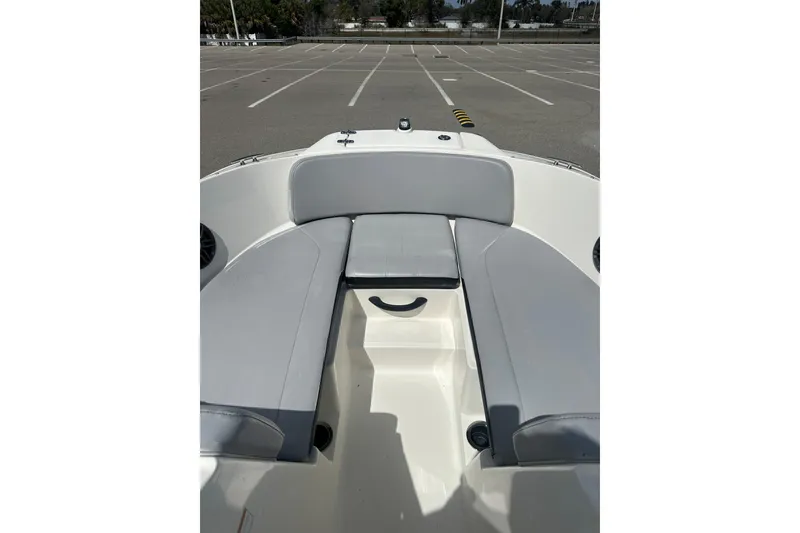 Slide: The Image of 2022 Sea Ray SPX 210 Outboard helm with steering wheel and dashboard controls. - 17