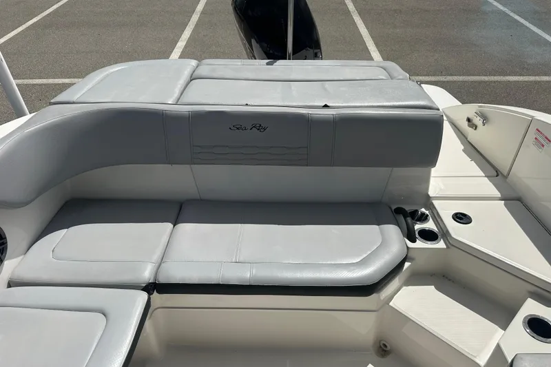 Slide: The Image of 2022 Sea Ray SPX 210 Outboard boat interior with gray seating and cup holders. - 22