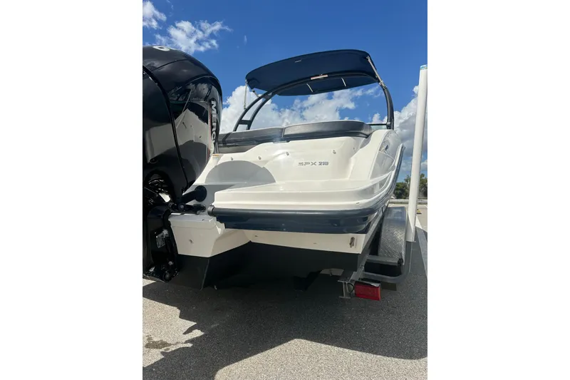 Slide: The Image of 2022 Sea Ray SPX 210 Outboard boat on trailer in sunny parking lot. - 3