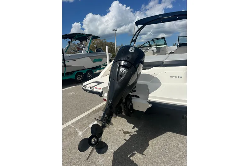 Slide: The Image of 2022 Sea Ray SPX 210 Outboard boat on trailer, covered and parked outdoors. - 4