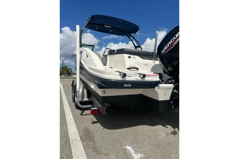 Slide: The Image of 2022 Sea Ray SPX 210 Outboard boat with blue cover in parking lot. - 5