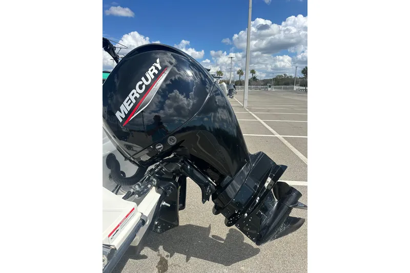 Slide: The Image of 2022 Sea Ray SPX 210 Outboard boat with powerful engine, parked under blue sky. - 7