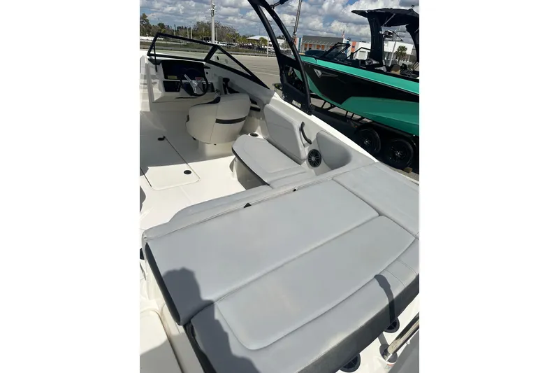 Slide: The Image of 2022 Sea Ray SPX 210 Outboard boat interior with seating and open deck under blue sky. - 8